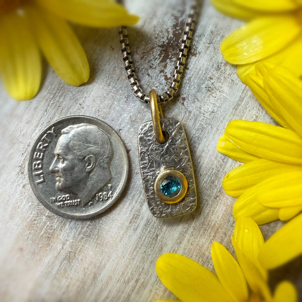 Mini Vertice with London Blue Topaz set in 18k gold.